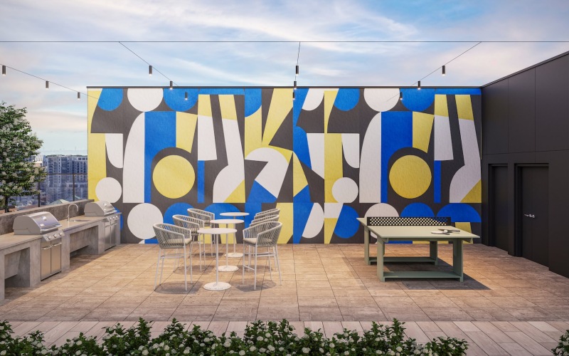 a grill area with tables, chairs and a ping pong table