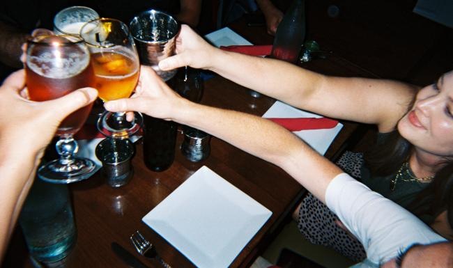 a group of people holding glasses of beer